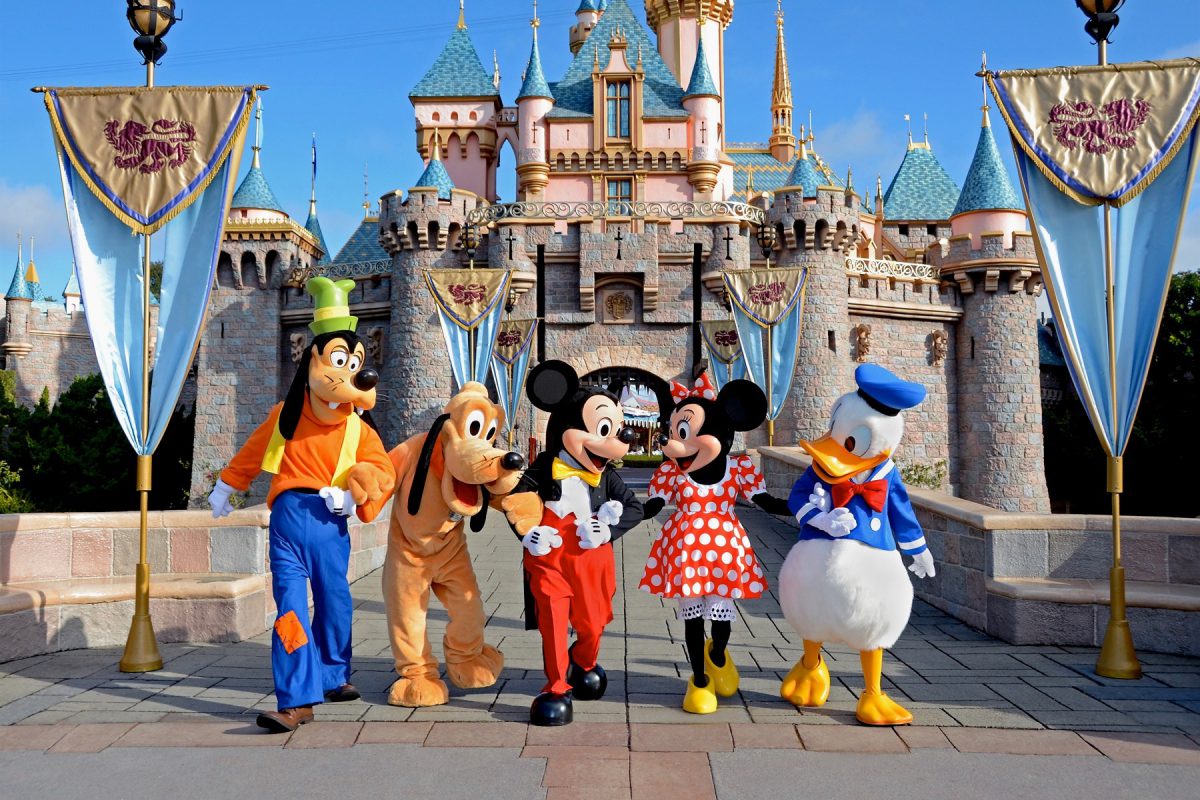 Disney characters in front of the Disneyland castle