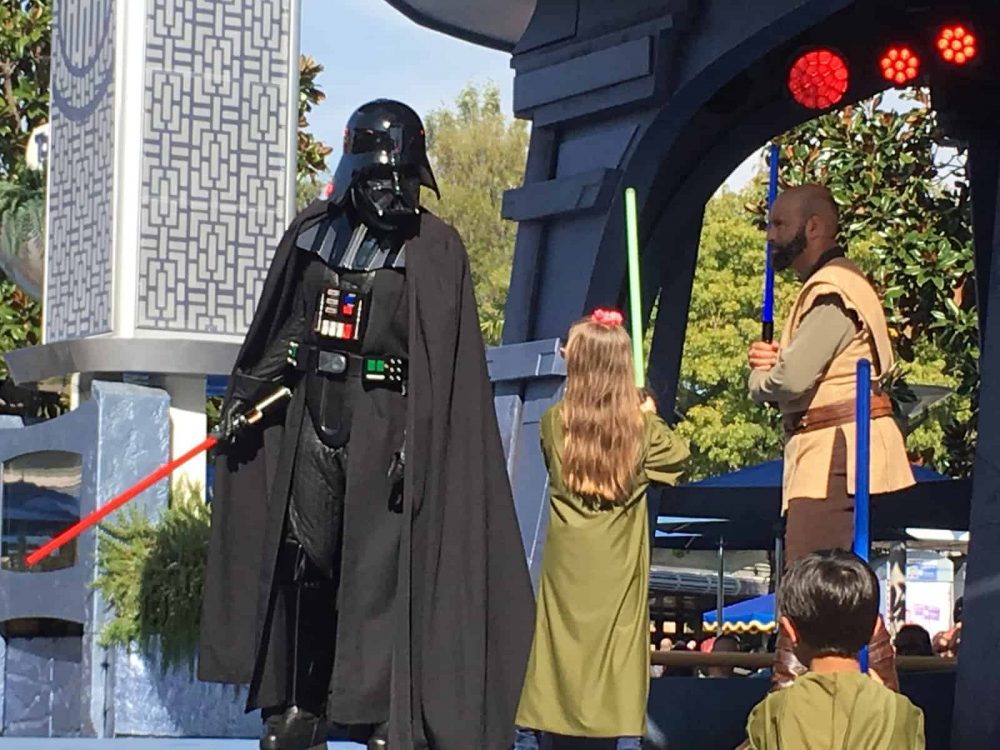 Emma fighting off Darth Vader at Disneyland