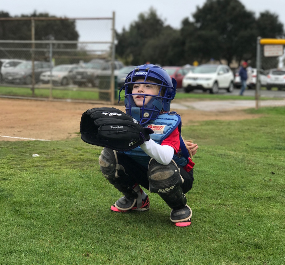 Our daughter in her second year of softball, playing catcher.