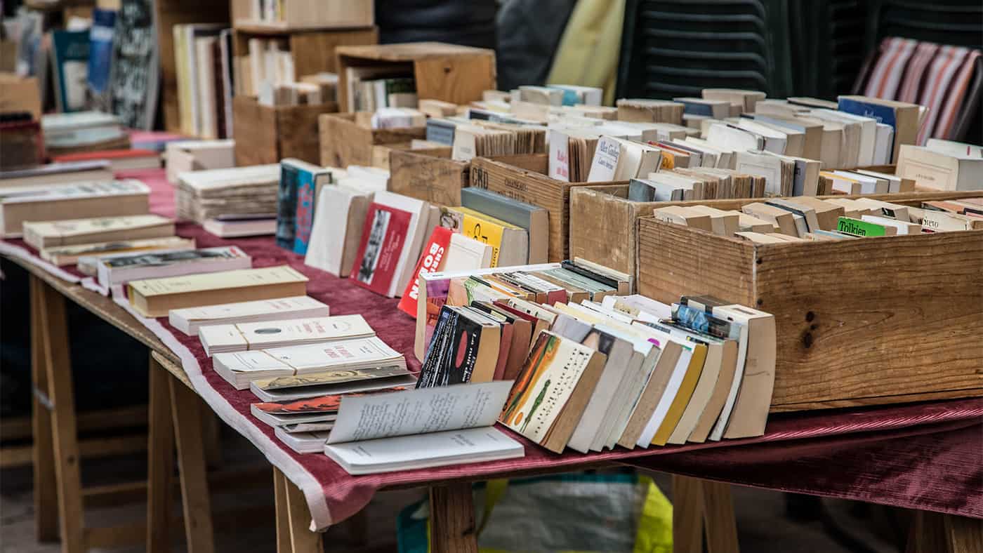 Books for sale at a yard sale.