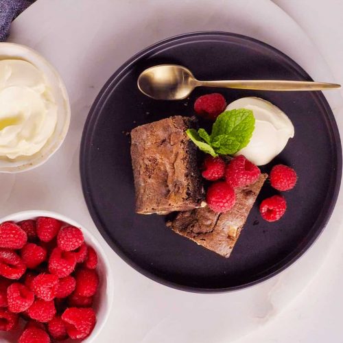 brownies with raspberries and whipped cream. 