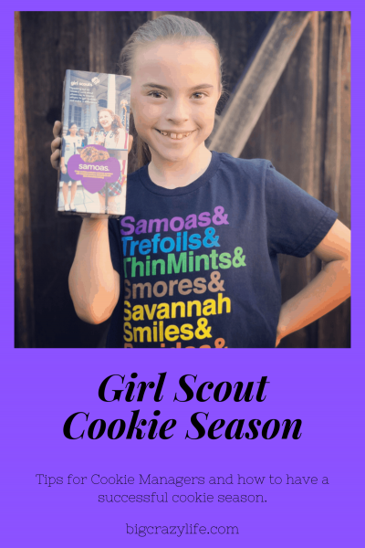 Girl Scout holding cookie box