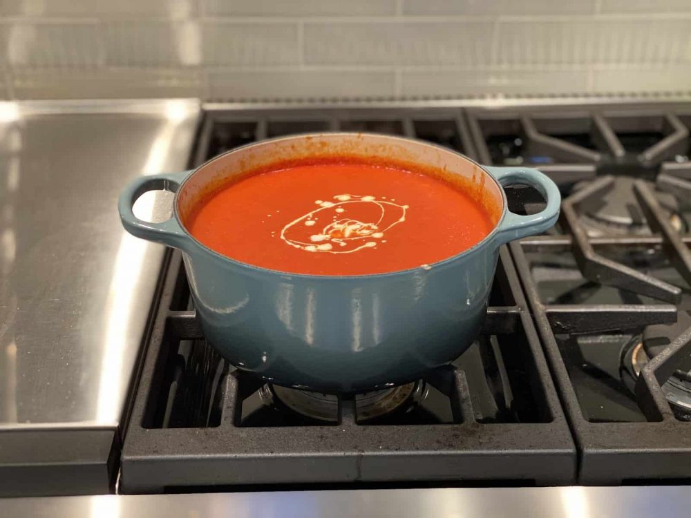 adding heavy cream to soup