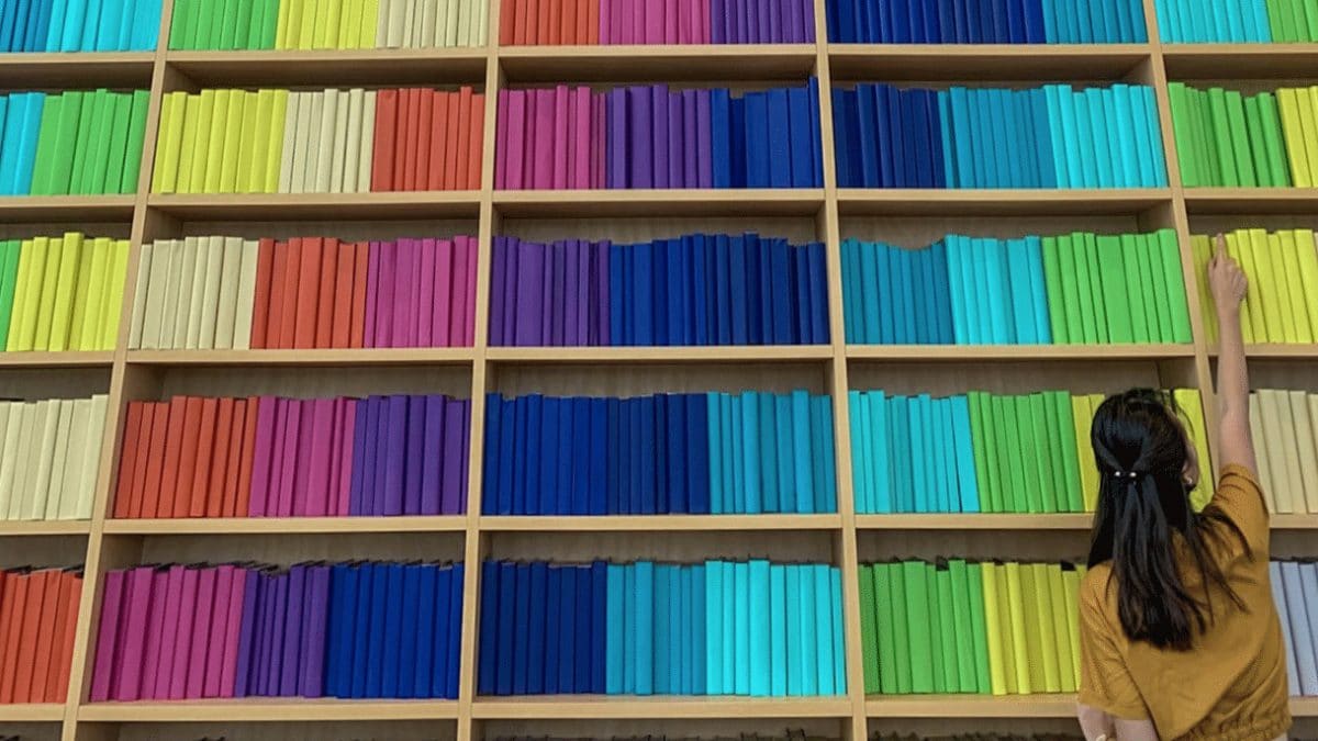 shelves and shelves of rainbow-colored books